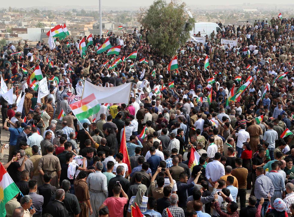 Iraqis wave Kurdish flags as they gather in support of the upcoming independence referendum in Kirkuk next week