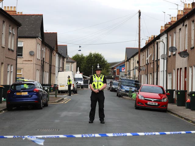 A police officer stands about a cordon near a home being searched in relation to the Parsons Green attack on 20 September in Newport, Wales