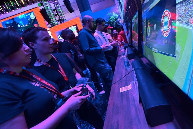 Gaming fans sample EA Sports FIFA 18 as Bayern Munich play Real Madrid on the screen at the Los Angeles Convention Center on day one of E3 2017