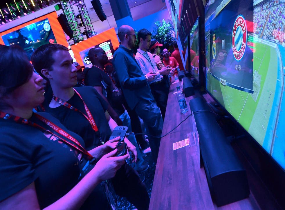 Gaming fans sample EA Sports FIFA 18 as Bayern Munich play Real Madrid on the screen at the Los Angeles Convention Center on day one of E3 2017
