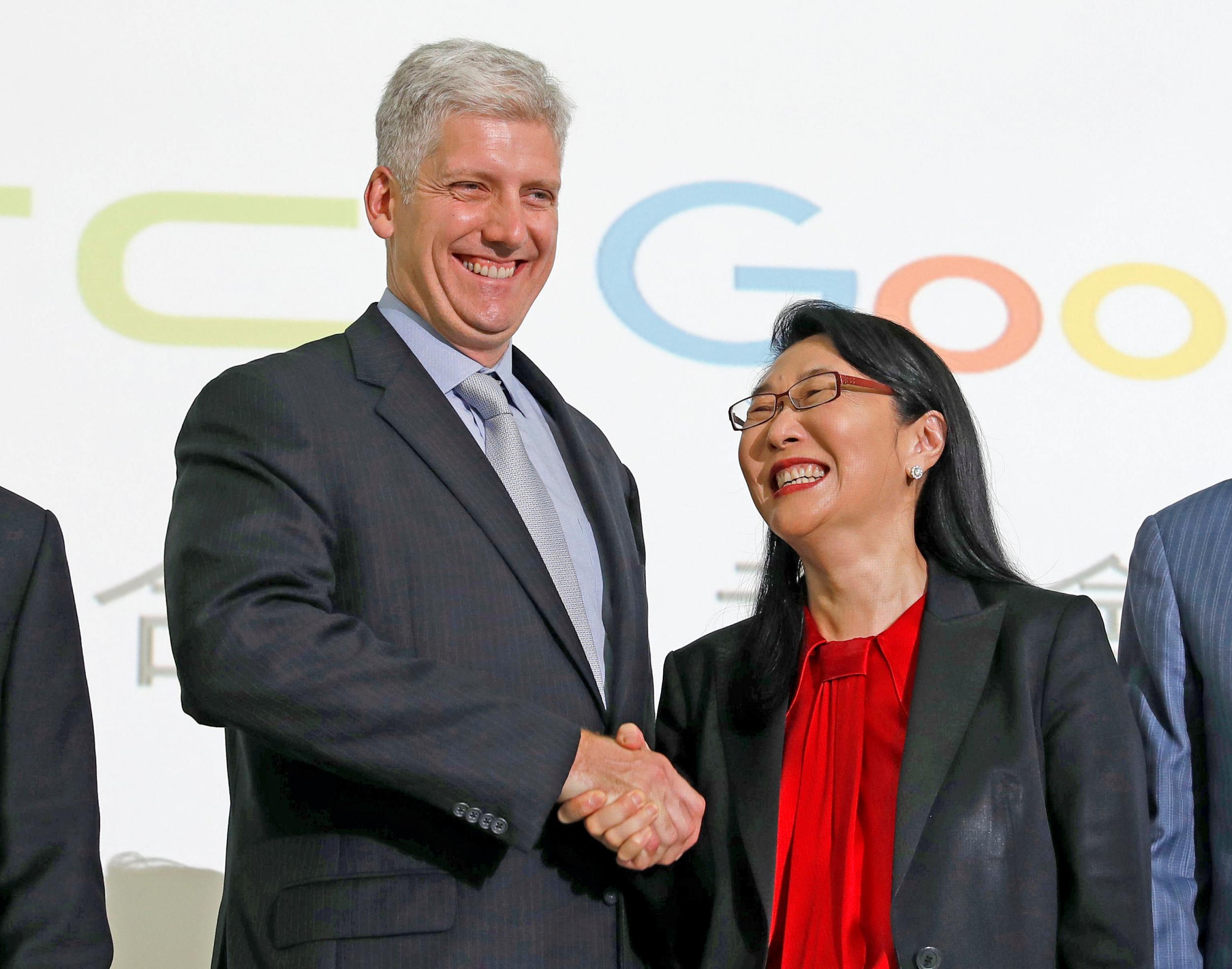 Google hardware executive Rick Osterloh shakes hand with HTC CEO Cher Wang