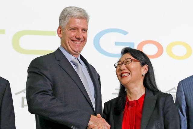 Google hardware executive Rick Osterloh shakes hand with HTC CEO Cher Wang