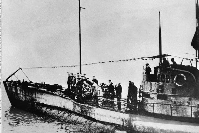 People stand on the deck of a World War I German submarine type UC-97
