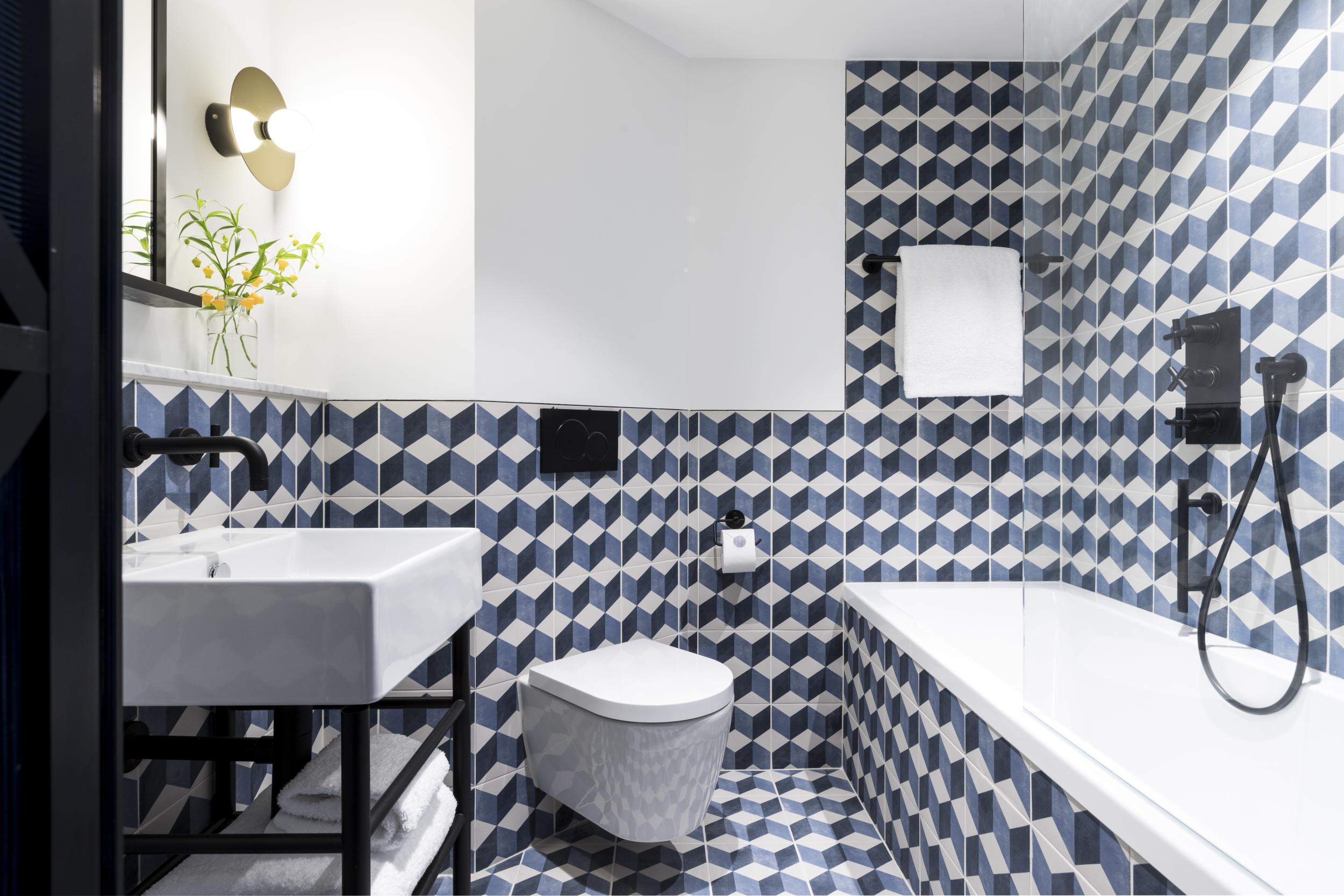 Bathrooms feature geometric tiles