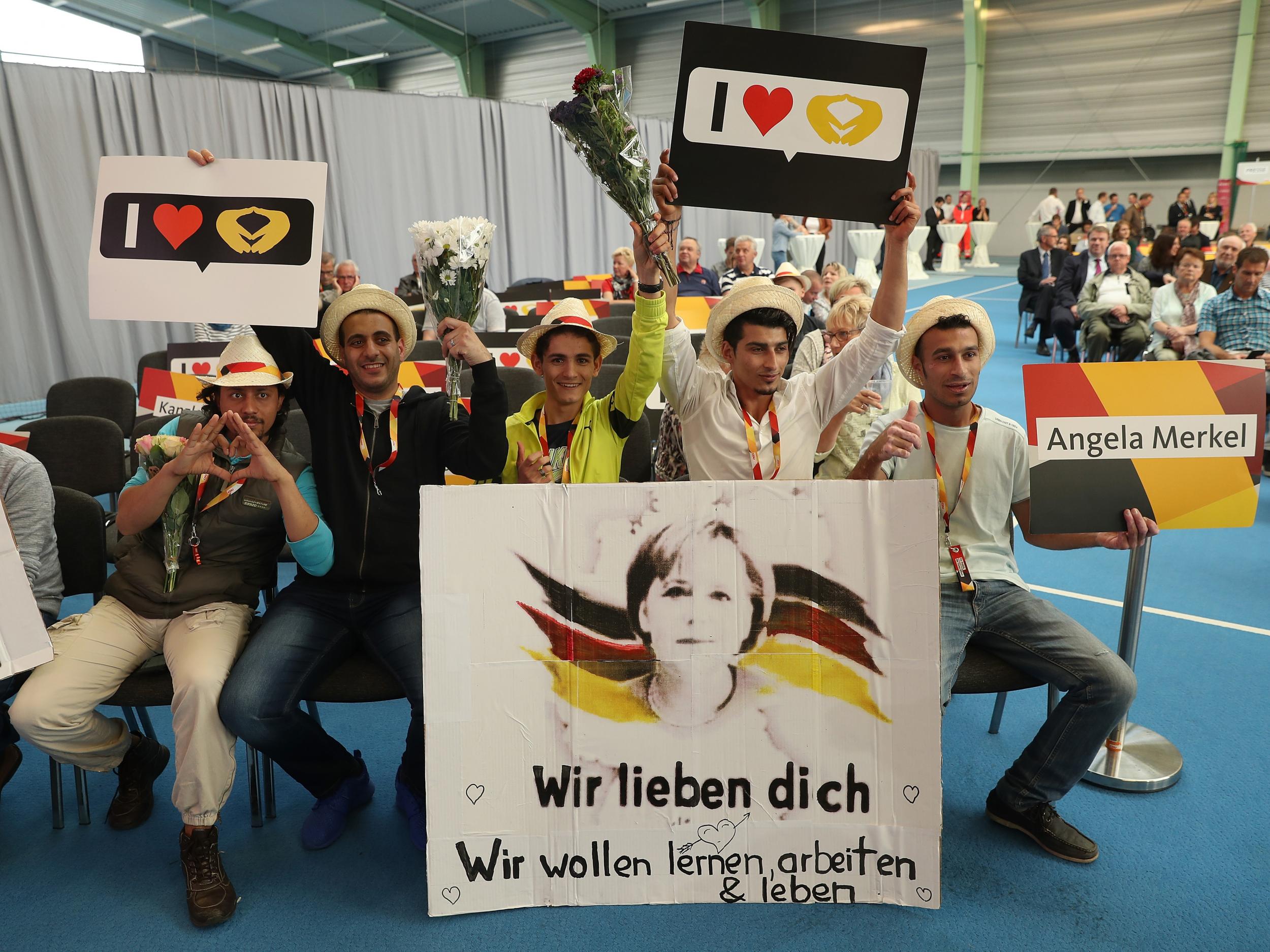 Refugees from Syria prior to the arrival of German Chancellor and Christian Democrat (CDU) Angela Merkel at an election campaign stop on September 19, 2017 in Schwerin