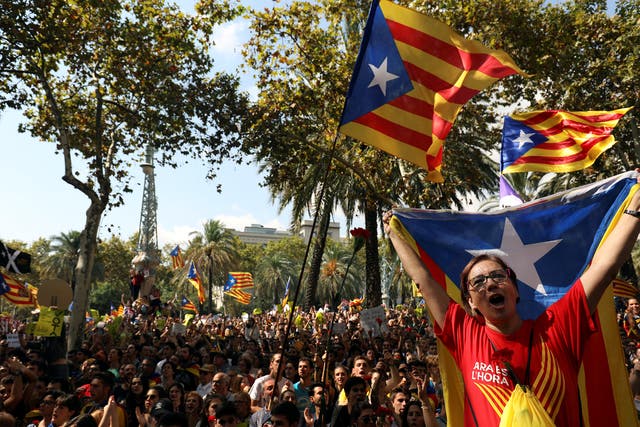Protesters wave Catalan separatist flags outside the High Court of Justice of Catalonia in Barcelona