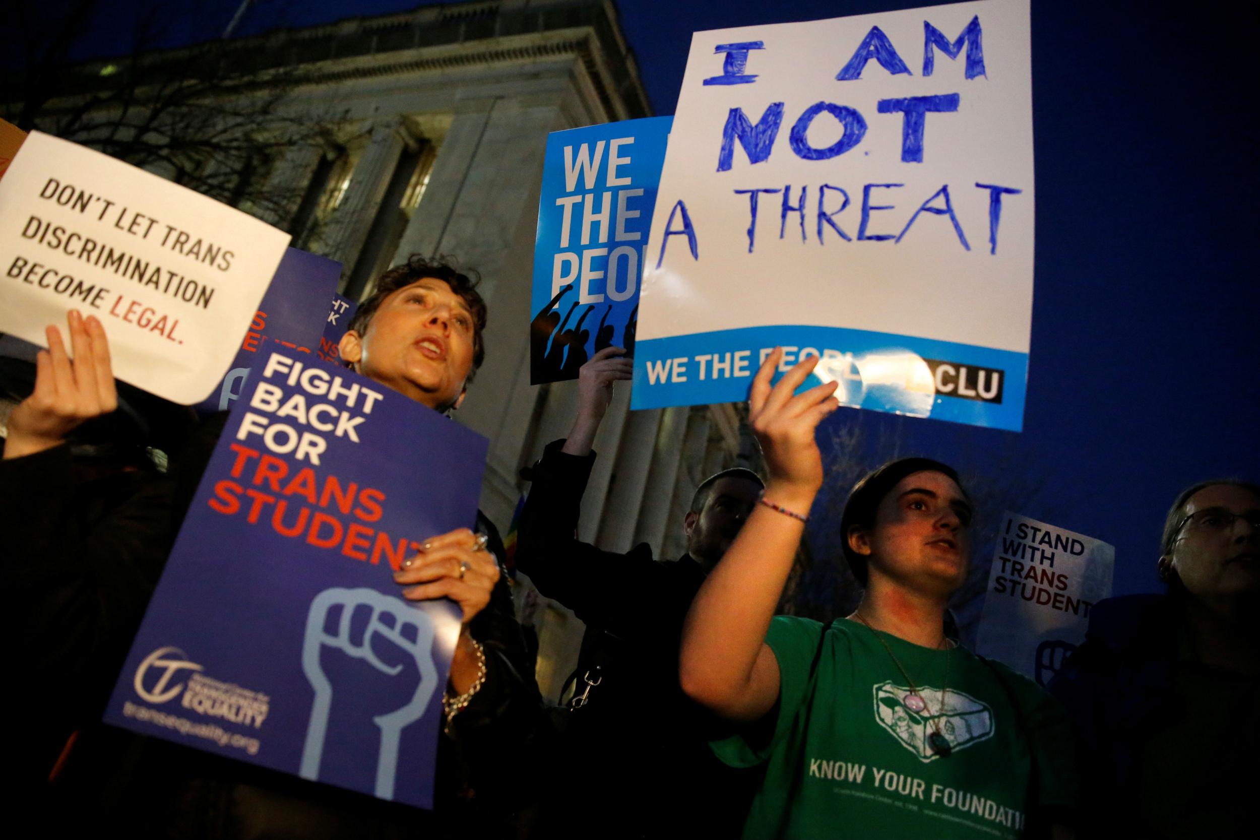 Transgender activists and supporters protest the Trump administrations' policies on transgender students near the White House on February 22, 2017.