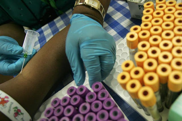 A nurse draws blood from a patient for an HIV test at the Themba Lethu Clinic in Johannesburg, South Africa.