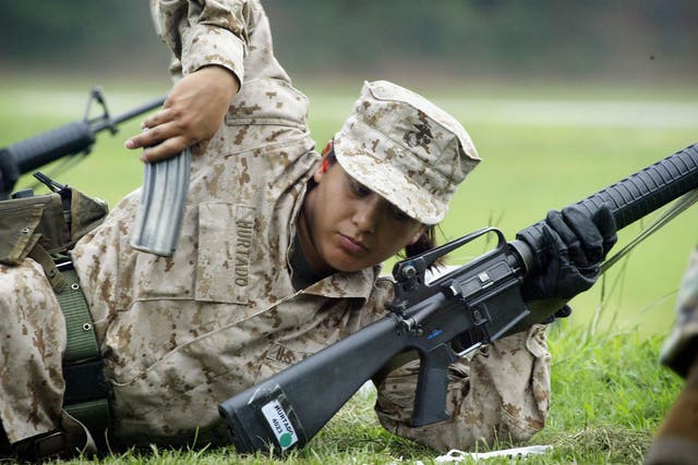A Female Marine Corps recruit loads her rifle while training on the rifle range at the United States Marine Corps recruit depot June 21, 2004 in Parris Island, South Carolina.