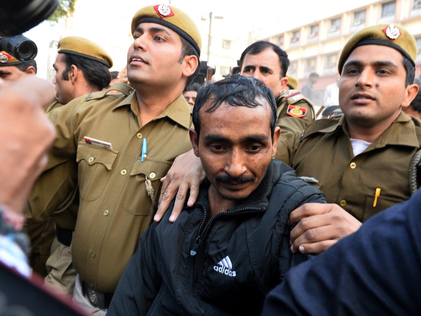 Indian police escort Uber taxi driver and convicted rapist Shiv Kumar Yadav following his court appearance in New Delhi on 8 December, 2014. An Uber executive, Eric Alexander, was fired in June of this year after reportedly obtaining the records of the rapist