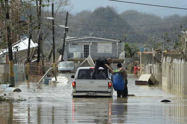 Rescue workers splash through flood waters in Puerto Rico