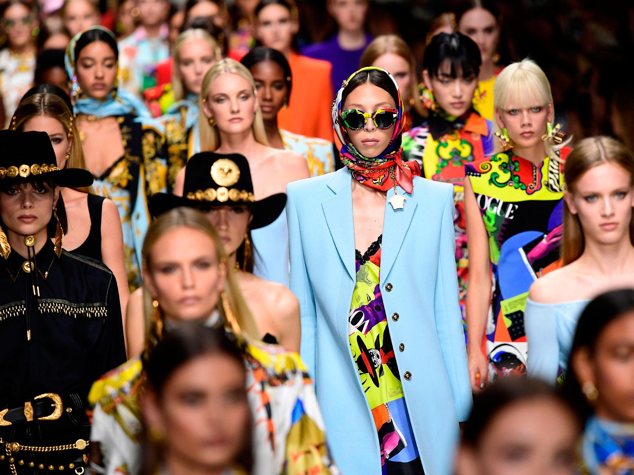 Models present creations for fashion house Versace during the Women's Spring/Summer 2018 fashion shows in Milan, on September 22, 2017