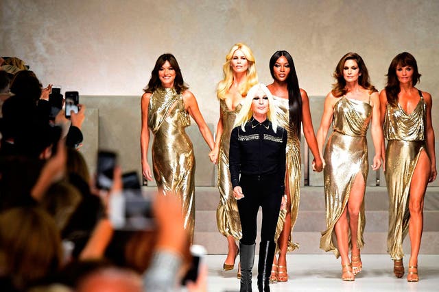 Supermodels (from left) Carla Bruni, Claudia Schiffer, Italian designer Donatella Versace (C), Naomi Campbell, Cindy Crawford and Helena Christensen walk the runway at the end of the show for Versace 