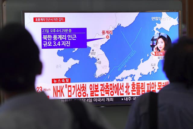 A man watches a television news screen showing a map of the epicenter of an earthquake in North Korea, at a railway station in Seoul on September 23, 2017.
China's seismic service CENC on September 23 detected a zero-depth, 3.4-magnitude earthquake in North Korea, calling it a "suspected explosion". There seemed to be some initial difference of opinion, however, with Seoul's Korea Meteorological Agency (KMA) saying that it had registered a tremor of a similar size, but judged it a "natural quake". / AFP PHOTO / JUNG Yeon-JeJUNG YEON-JE/AFP/Getty Images