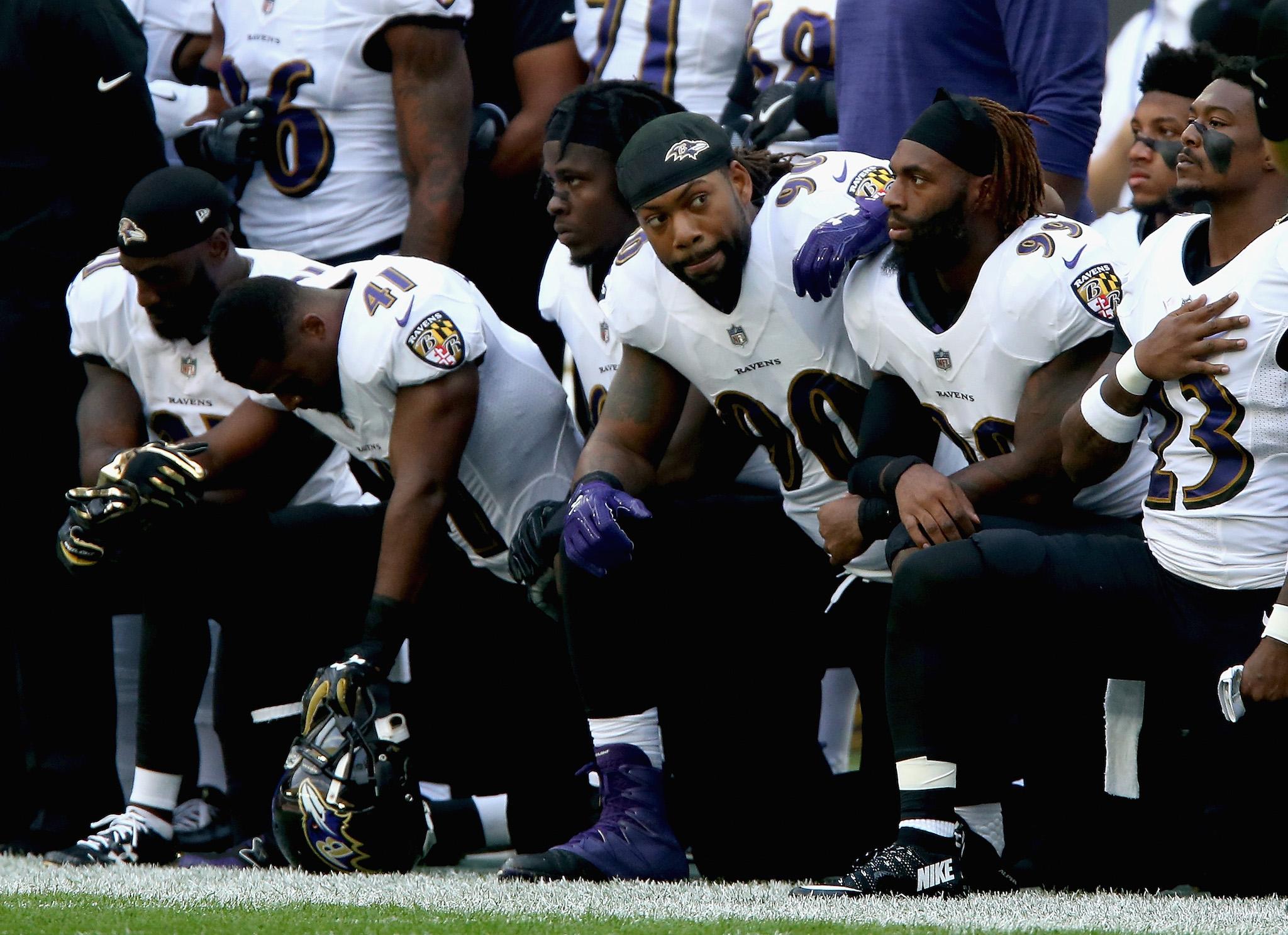 Baltimore Ravens players kneel for the American National anthem during the NFL International Series match between Baltimore Ravens and Jacksonville Jaguars at Wembley Stadium