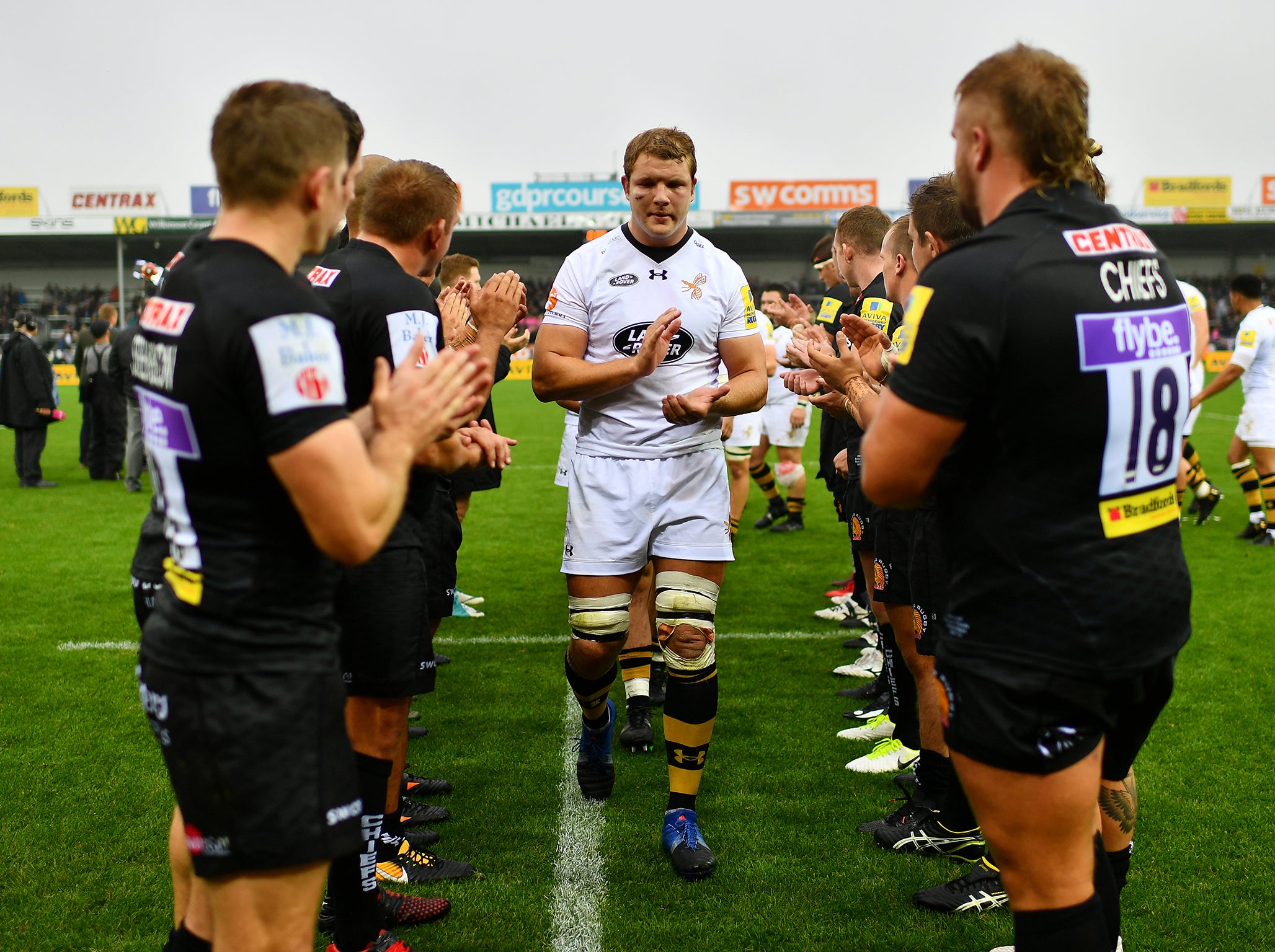 Joe Launchbury of Wasps leads his team off the field following