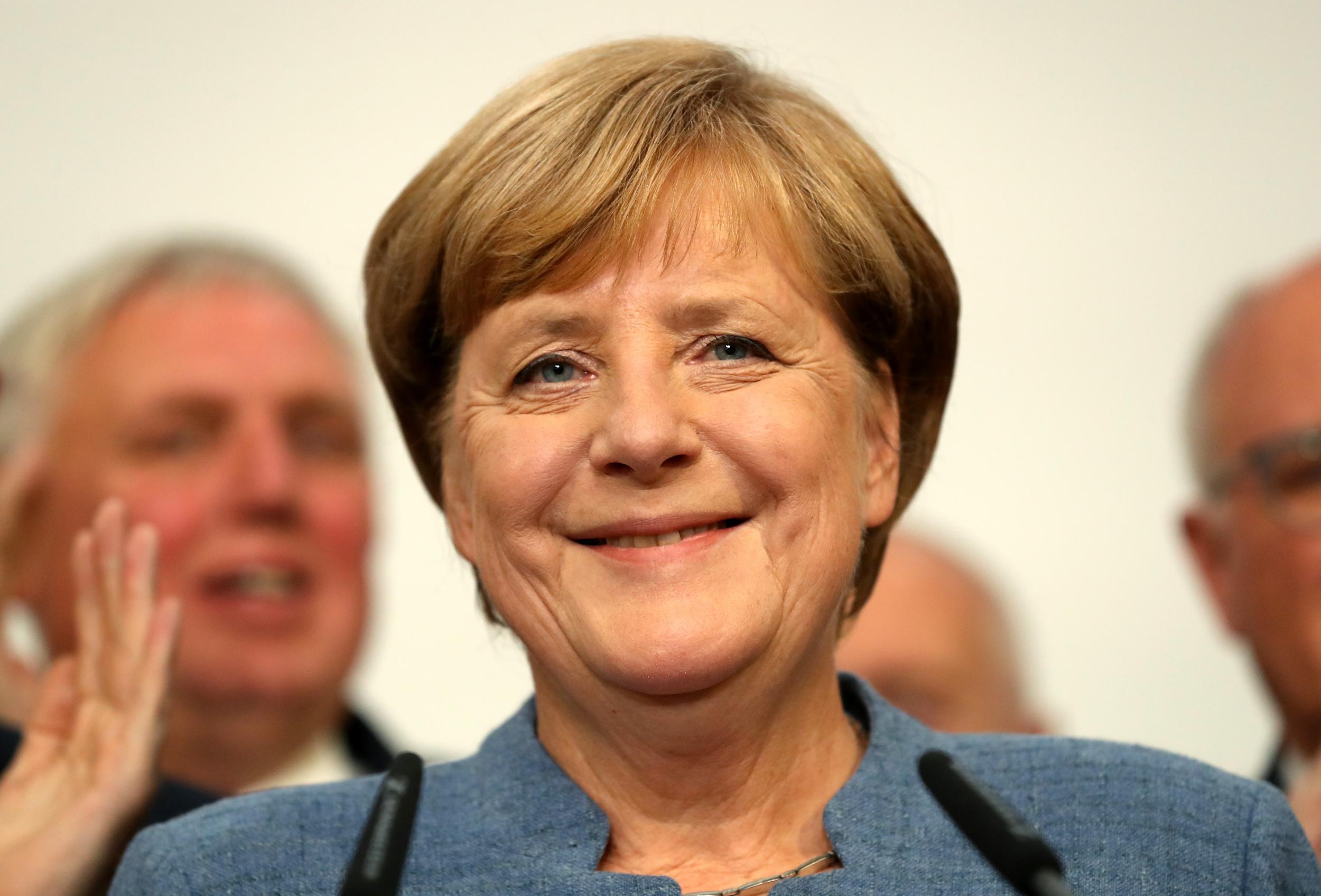 Angela Merkel speaks after initial results show her on course to win a fourth term