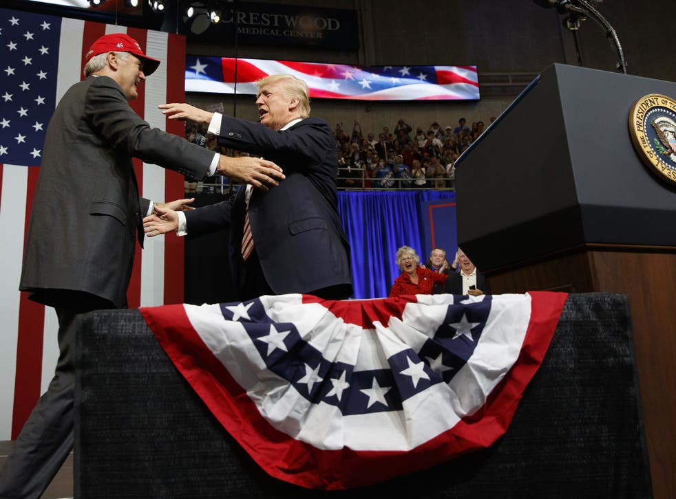 The President hugs US Senate candidate Luther Strange during a campaign rally