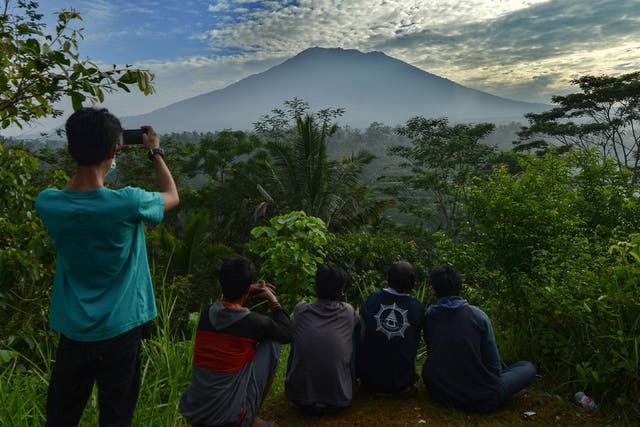 People look at Mount Agung in Karangasem on the Indonesian resort island of Bali