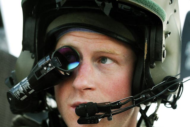 Prince Harry wears his monocle gun sight as he sits in the front seat of his Apache helicopter