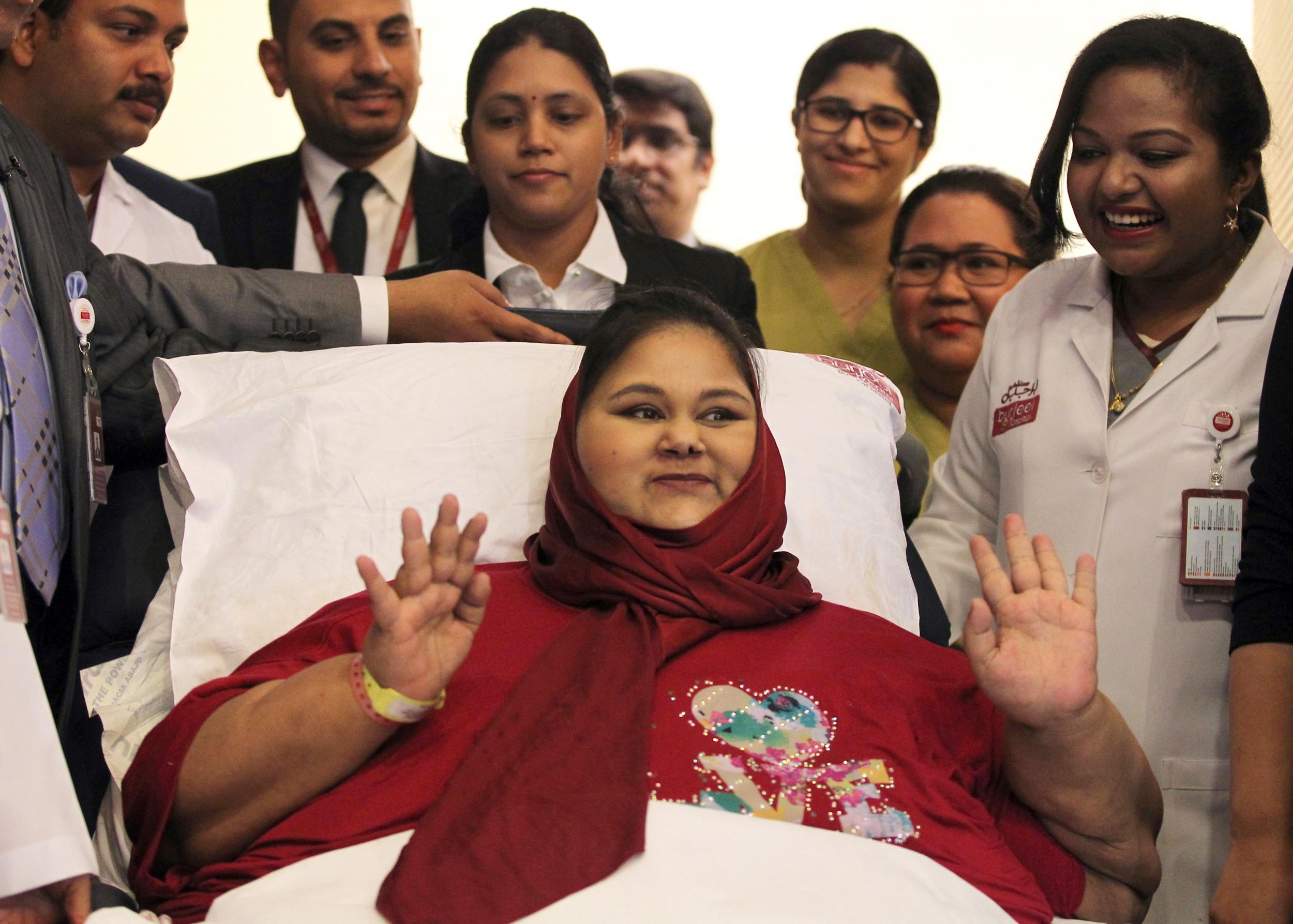 Eman Ahmed Abd El Aty waving during a press conference at the Burjeel Hospital in Abu Dhabi.