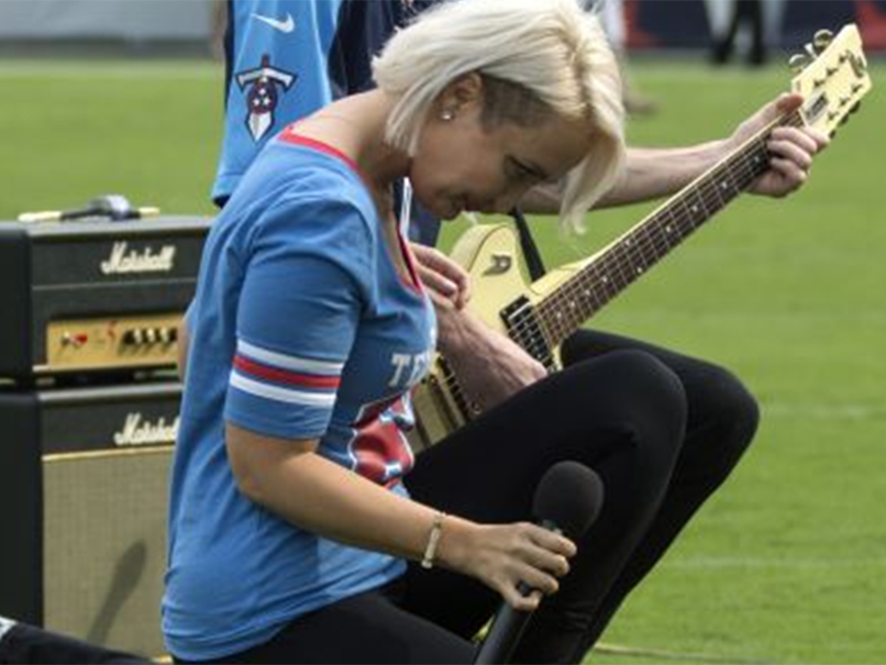 Former The Voice contestant Meghan Linsey ook a knee and bowed after performing the national anthem in support of NFL players protesting against racism in the US