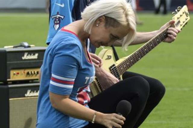 Former The Voice contestant Meghan Linsey ook a knee and bowed after performing the national anthem in support of NFL players protesting against racism in the US
