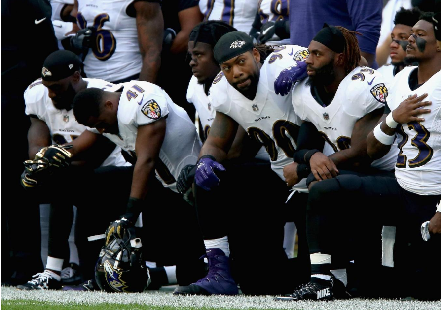Baltimore Ravens players kneel for the American National anthem during the NFL International Series at Wembley Stadium