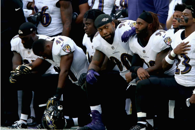 Baltimore Ravens players kneel for the American National anthem during the NFL International Series at Wembley Stadium