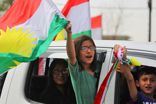 Iraqi children wave Kurdish flags in Kirkuk, but the vote has angered Baghdad and neighbours Turkey and Iran, where many Kurds live