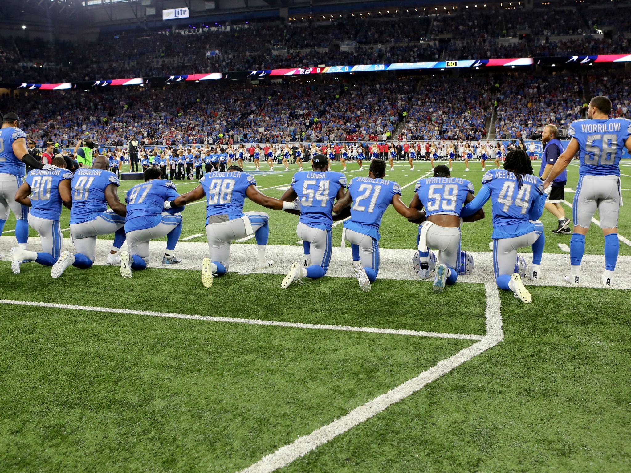 Members of the Detroit Lions take a knee during the playing of the national anthem prior to the start of the game against the Atlanta Falcons in Detroit, Michigan on 24 September.