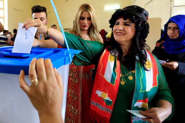 A woman casts her vote in the Kurdish independence referendum in Kirkuk, northern Iraq, on 25 September 2017