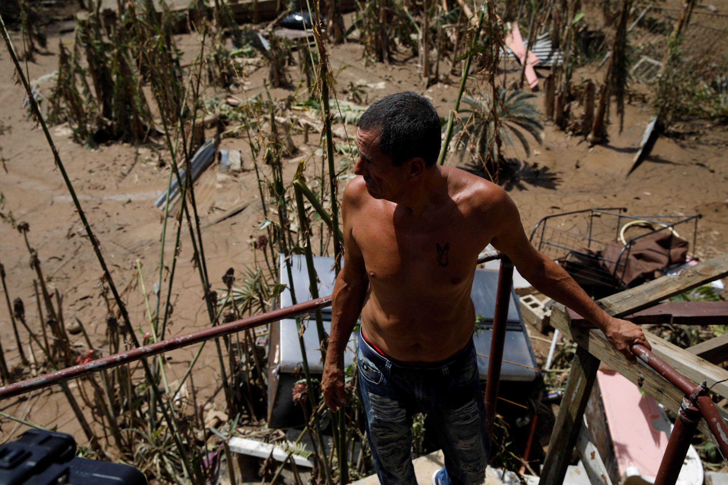 A man looks at the damage after his house was hit by Hurricane Maria in Toa Baja, Puerto Rico