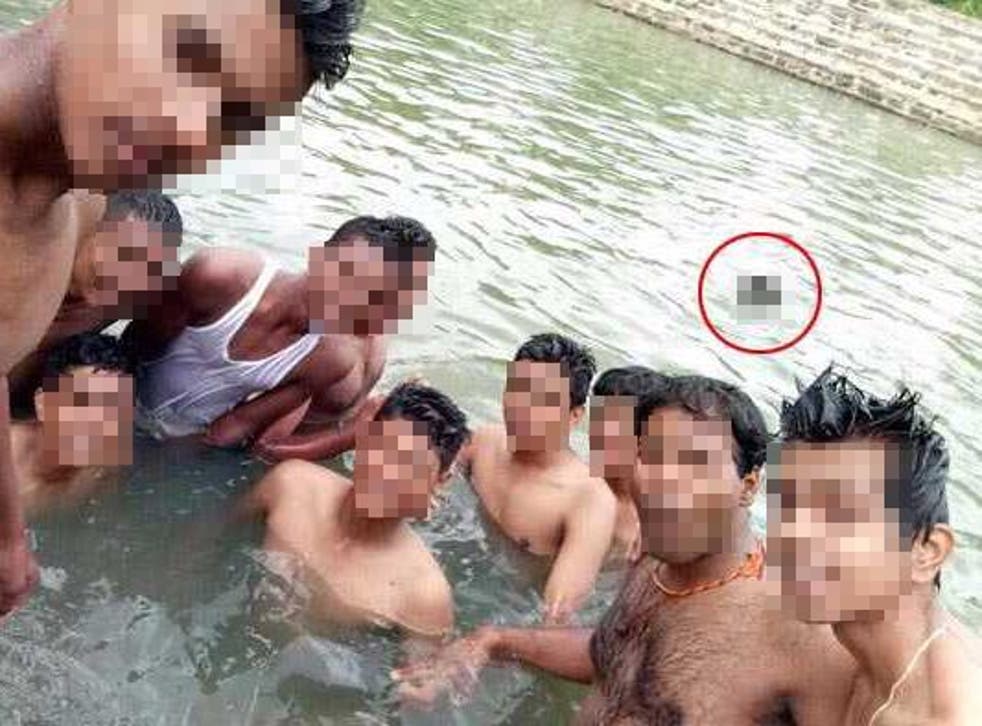 The image circulated on Indian social media showed a group taking a selfie with the drowning man (blurred) in the background