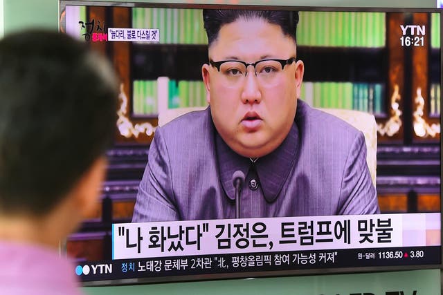 A man watches a television news screen showing a picture of North Korean leader Kim Jong-Un delivering a statement in Pyongyang, at a railway station in Seoul on 22 September 2017.
