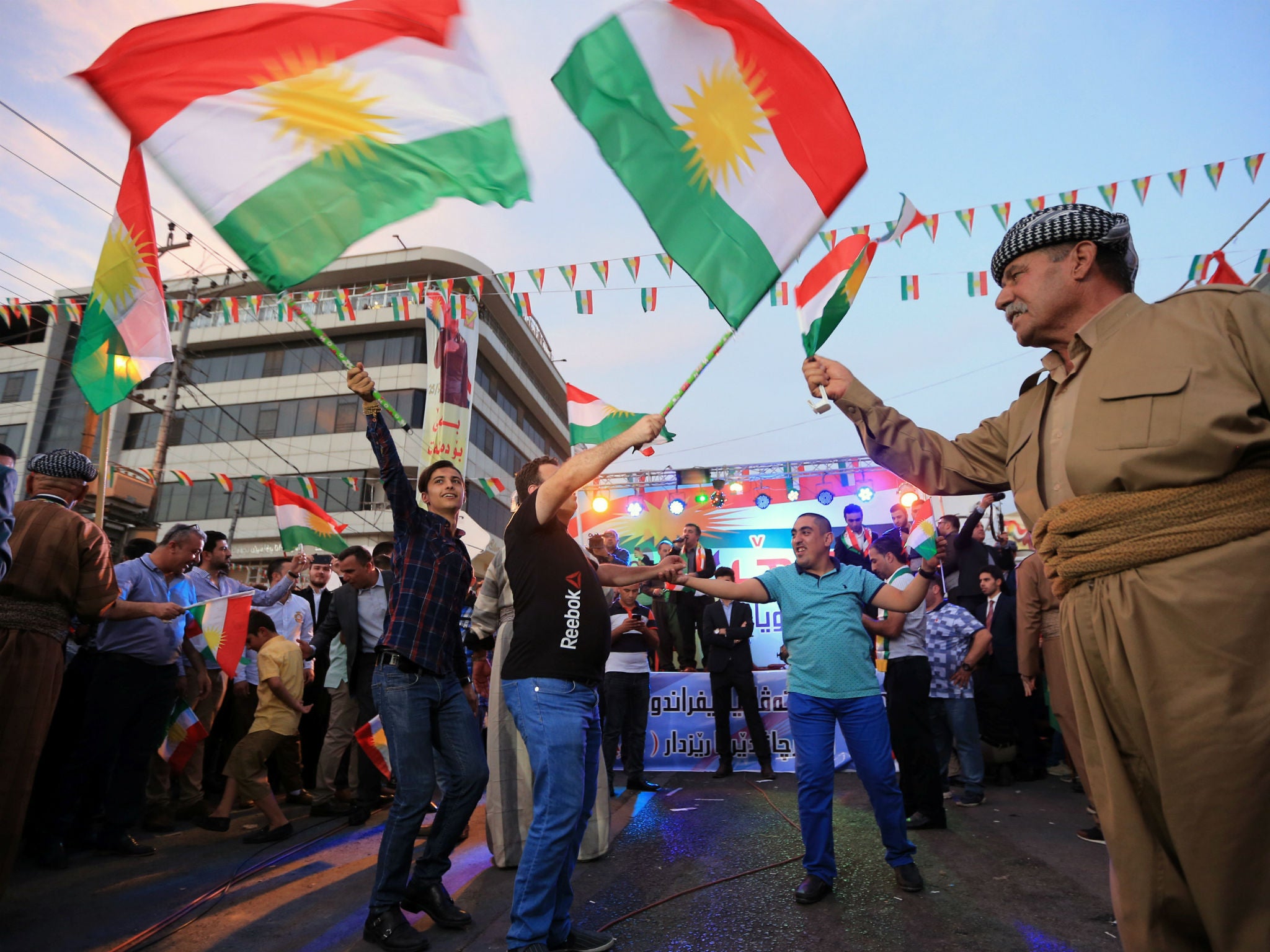 Kurds celebrate to show their support for the independence referendum in Duhok, Iraq