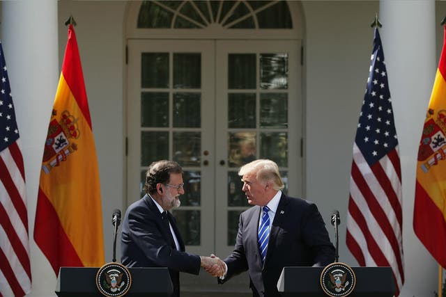 Donald Trump and Spanish Prime Minister Mariano Rajoy shake hands during a joint news conference at White House 26 September