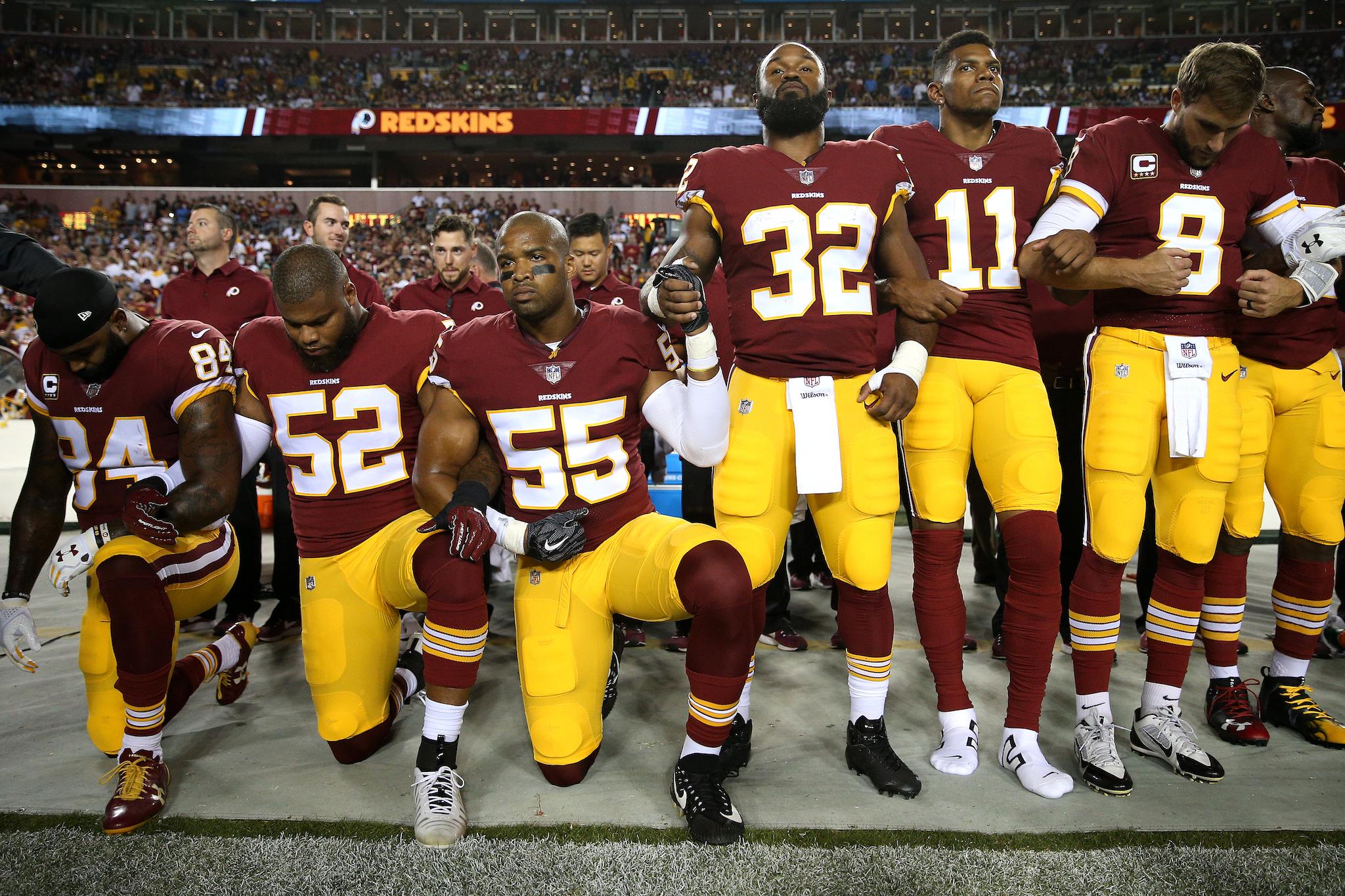 Washington Redskins players kneel in unison during the national anthem (Getty)