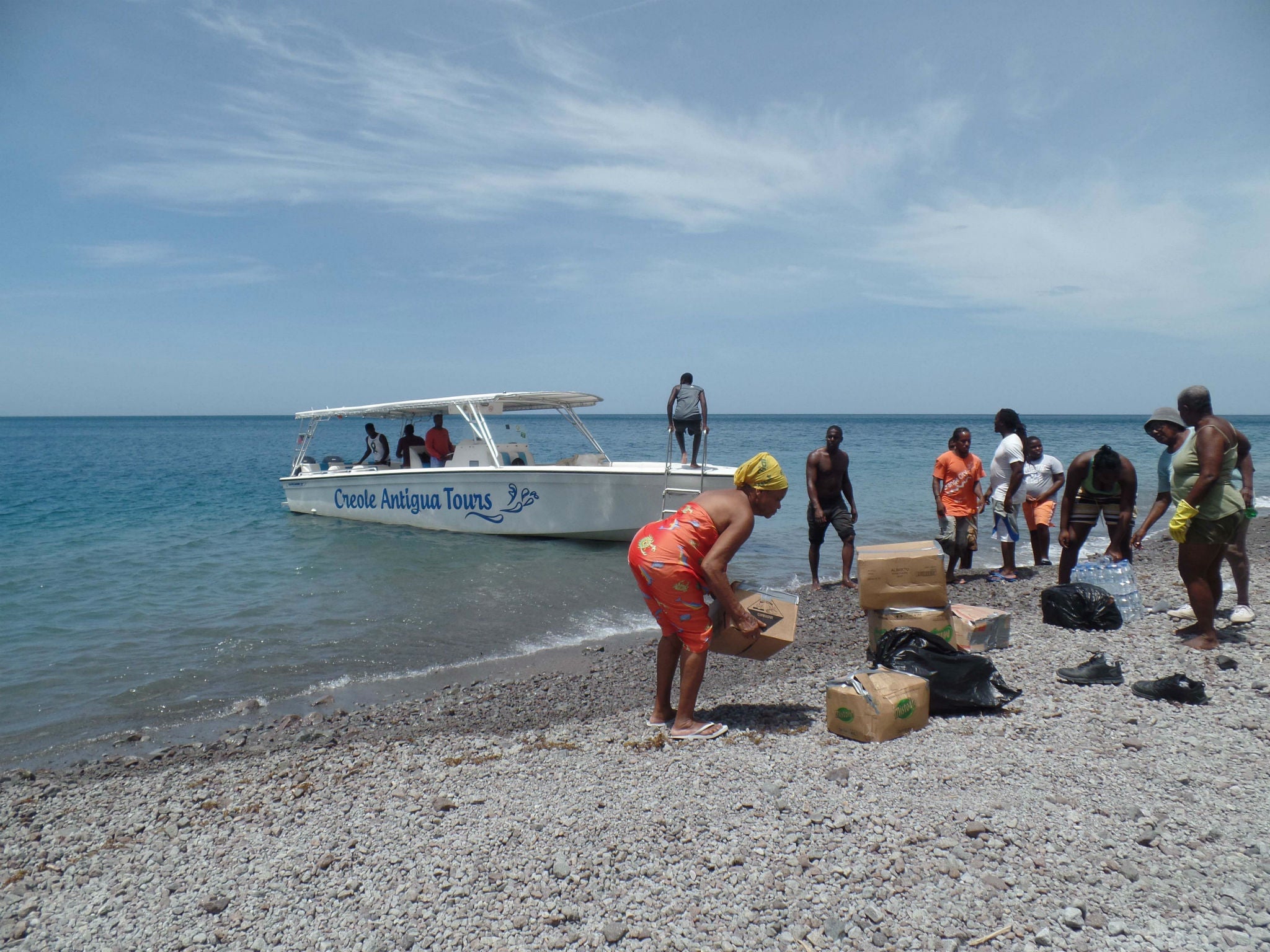 Unloading emergency supplies from a boat usually used for day trips in Antigua