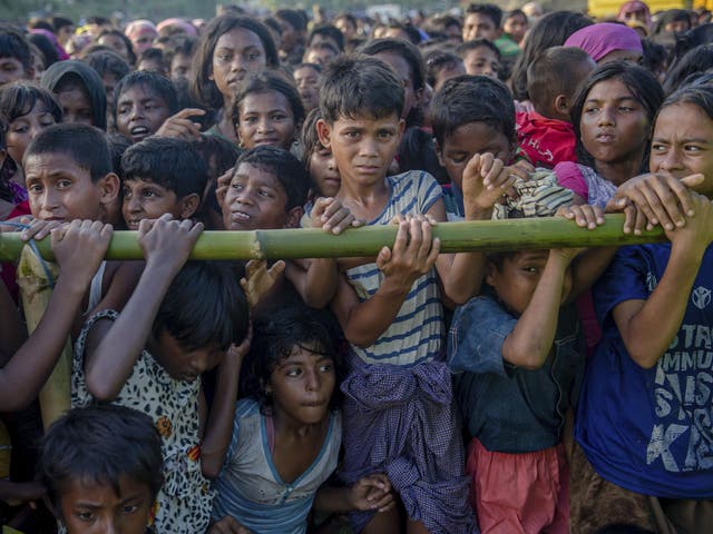 Rohingya children, who crossed over from Burma into Bangladesh, wait to receive aid during a distribution near Balukhali refugee camp, Bangladesh