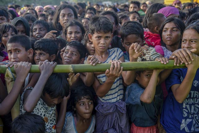 Rohingya children, who crossed over from Burma into Bangladesh, wait to receive aid during a distribution near Balukhali refugee camp, Bangladesh