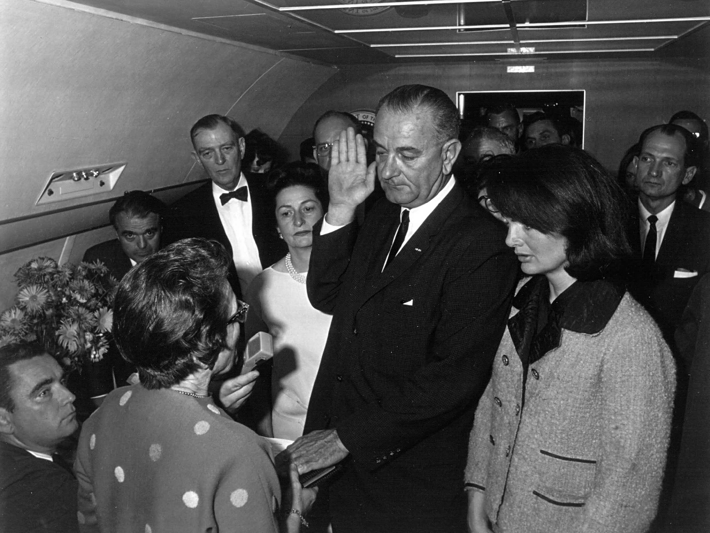 Lyndon B Johnson takes the oath of office as president, shortly after the assassination