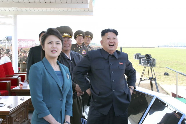 Mr Kim and wife Ms Ri attend the 2014 Combat Flight Contest among commanding officers of the Korean People's Air Force