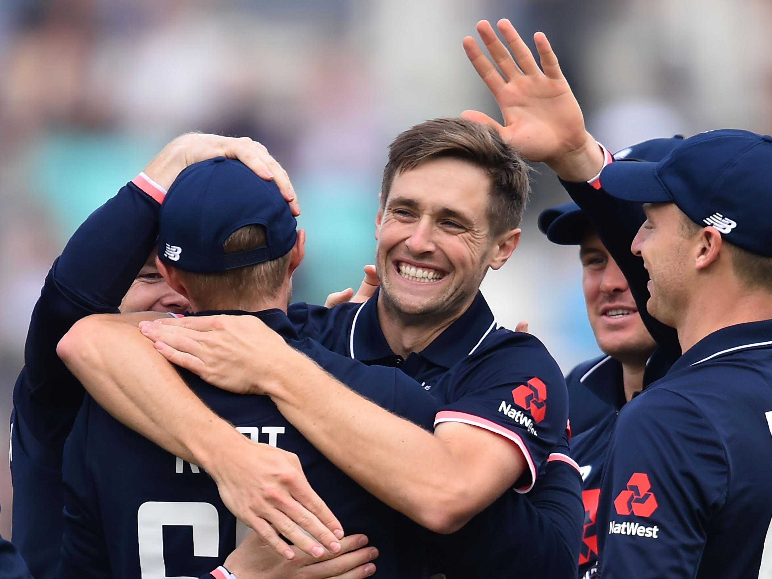 Chris Woakes celebrates the wicket of Chris Gayle