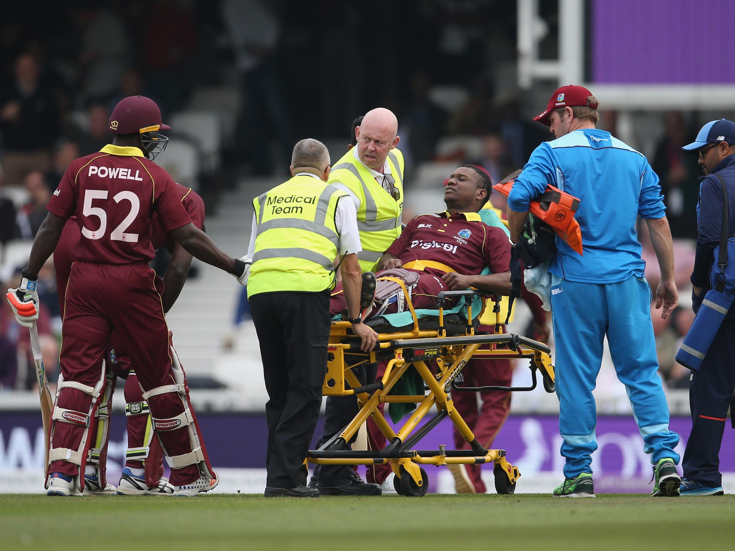 Evin Lewis is stretchered off after being struck in the ankle