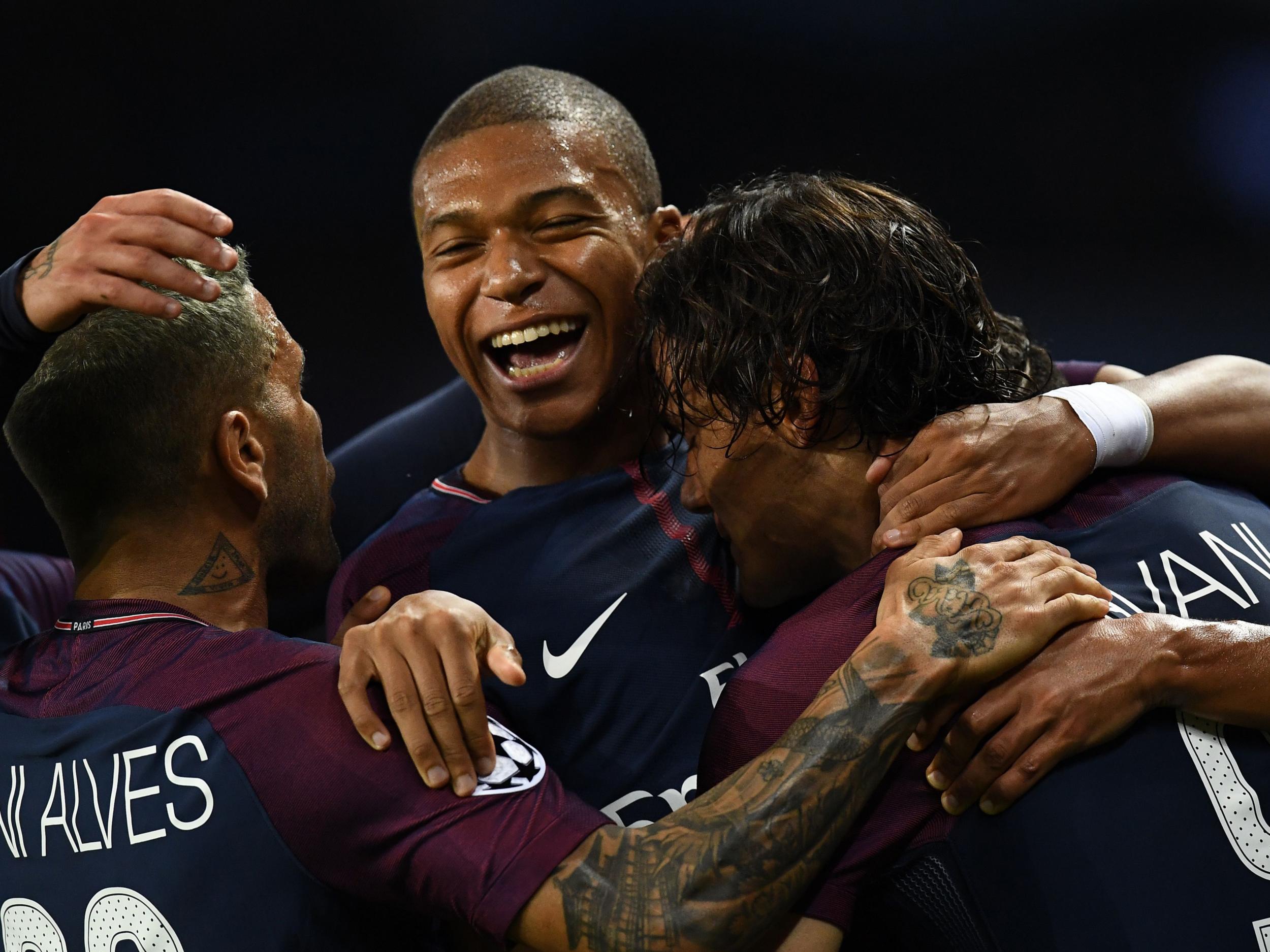 Edinson Cavani is congratulated by Mbappe and Alves after doubling PSG's lead