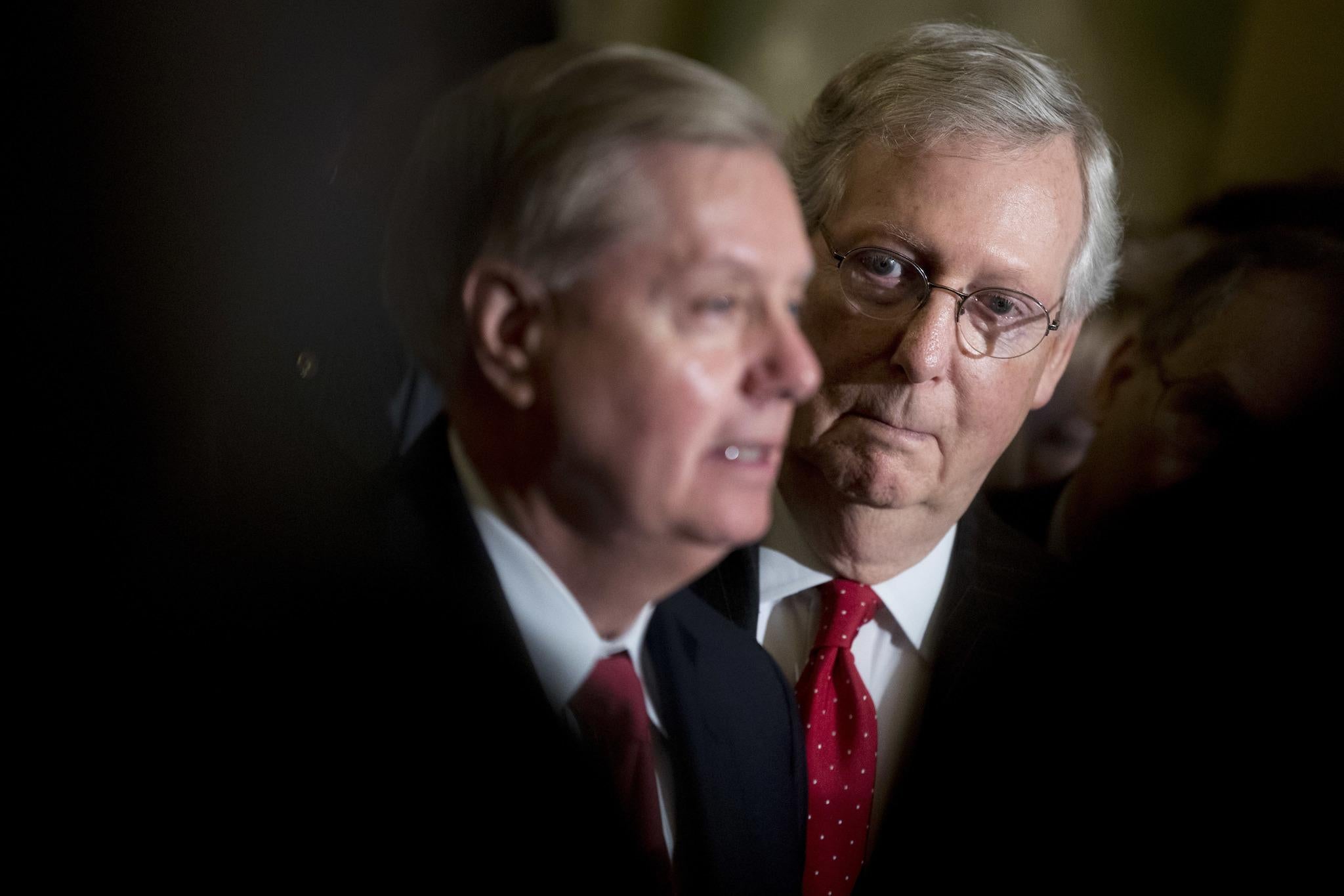 Republican Senator Lindsey Graham flanked by Senate Majority Leader Mitch McConnell