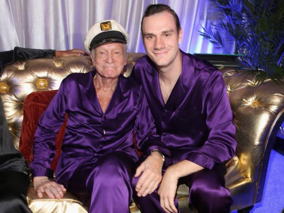 Cooper and his late father Hugh enjoy a moment during a party in the Playboy Mansion