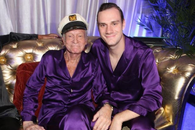 Cooper and his late father Hugh enjoy a moment during a party in the Playboy Mansion
