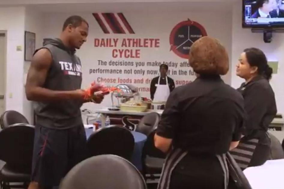 &#13;
As Watson tells the women about his donation... (Houston Texans)&#13;